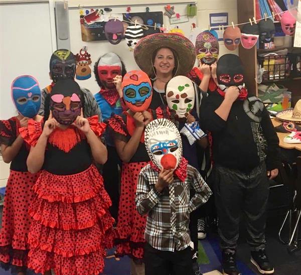 Spanish class students wearing culturally-inspired hand-made masks in classroom
